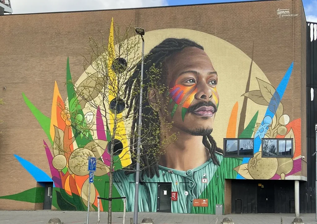 Bright example of Wall art in Rotterdam featuring a black man surrounded by brightly colored illustrations.